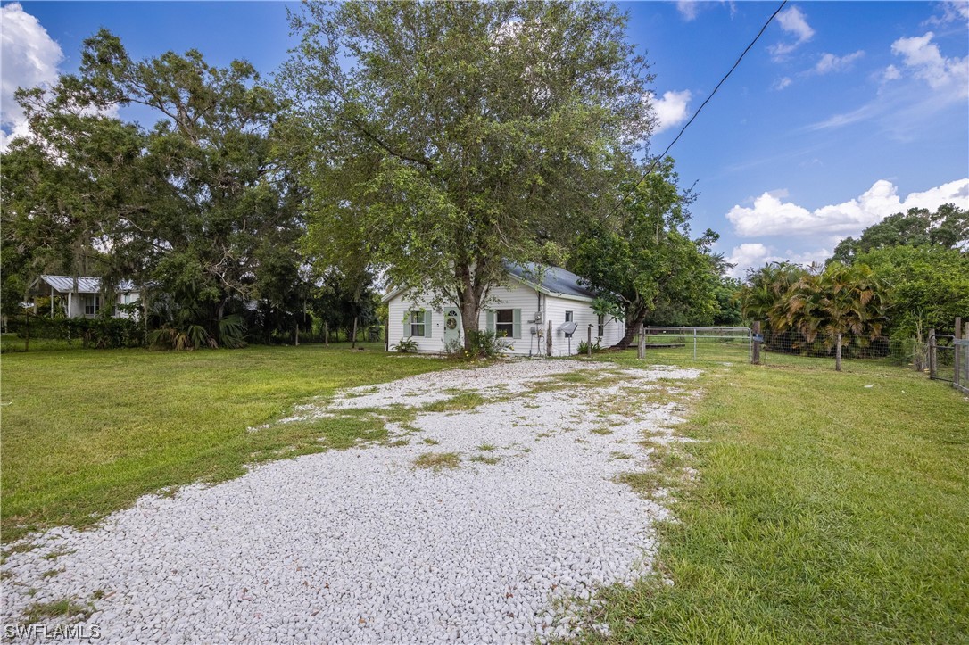 2701 Packinghouse Road Alva, FL 33920 - Photo 22 of 33 a front view of a house with a yard