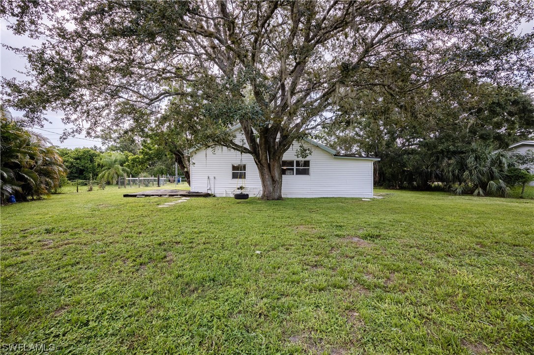 2701 Packinghouse Road Alva, FL 33920 - Photo 24 of 33 a view of a house with a yard