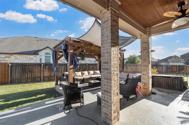 a view of a patio with a table and chairs