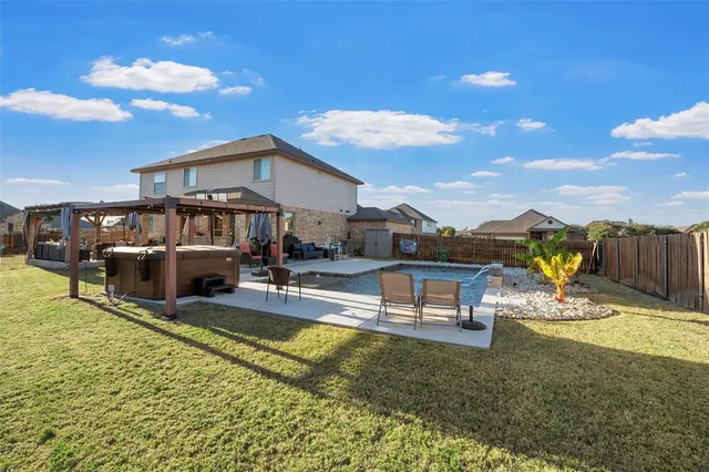 a view of a house with swimming pool and sitting area