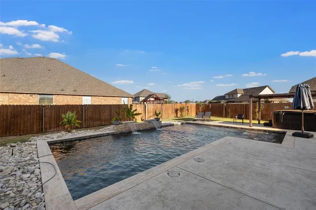 a view of a swimming pool and a yard