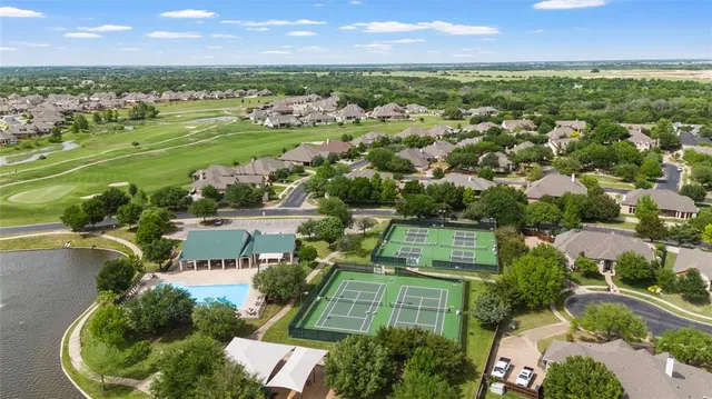 an aerial view of residential houses with outdoor space and river