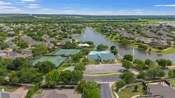 an aerial view of residential houses with outdoor space and lake view