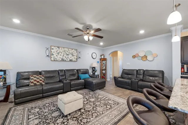 a living room with furniture and a chandelier