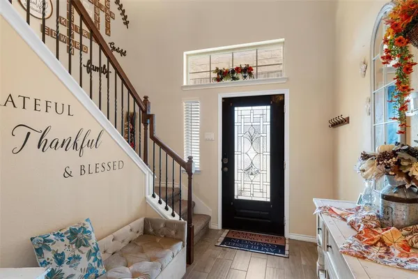 a view of an entryway with wooden floor