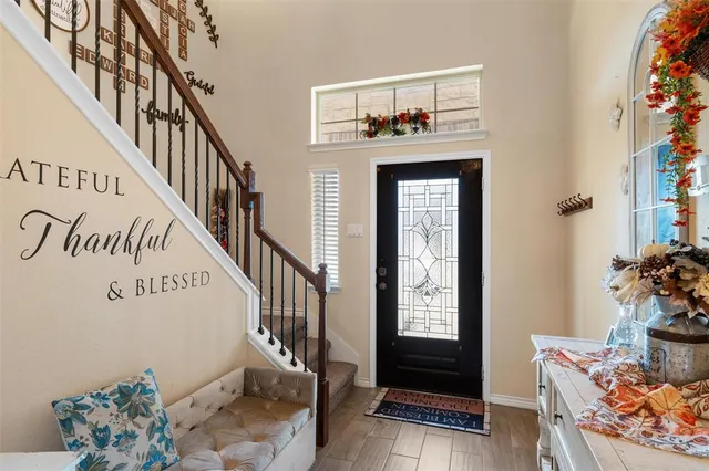a view of an entryway with wooden floor