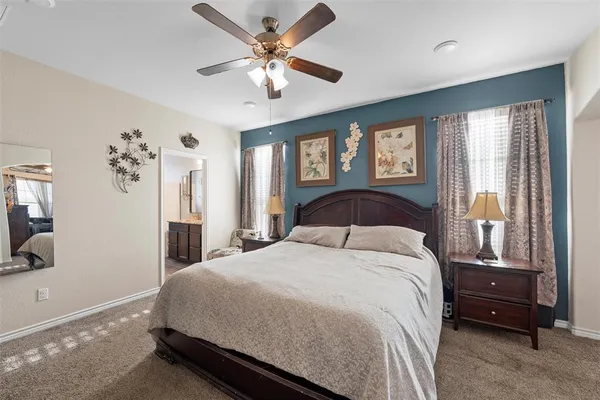 a bedroom with a large bed and a chandelier