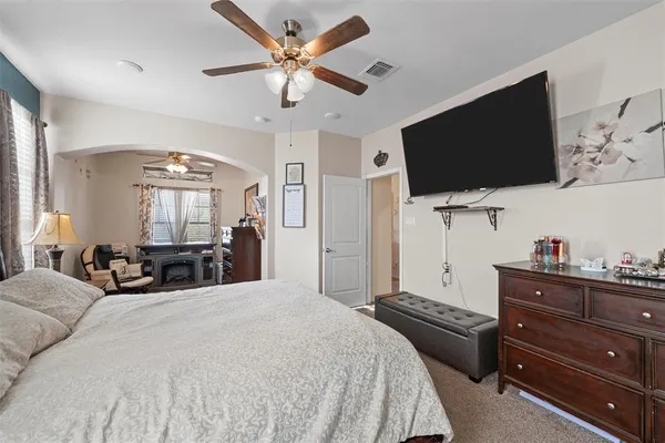 a bedroom with a bed and a flat screen tv