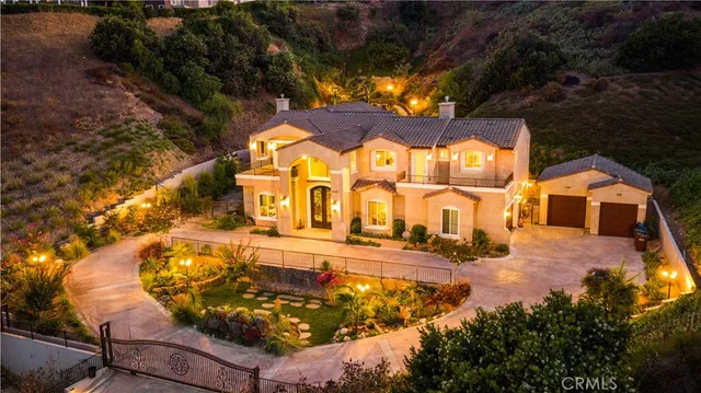 an aerial view of residential houses with outdoor space and trees