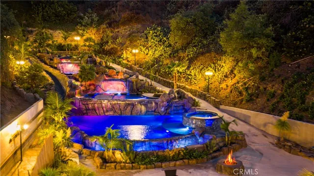a living room with furniture chess board and a potted plant