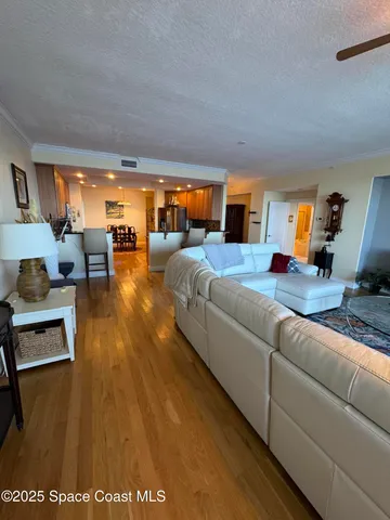 a living room with furniture wooden floor and a flat screen tv