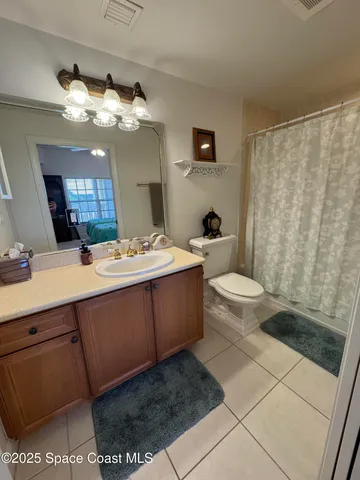 a bedroom with bed and a chandelier