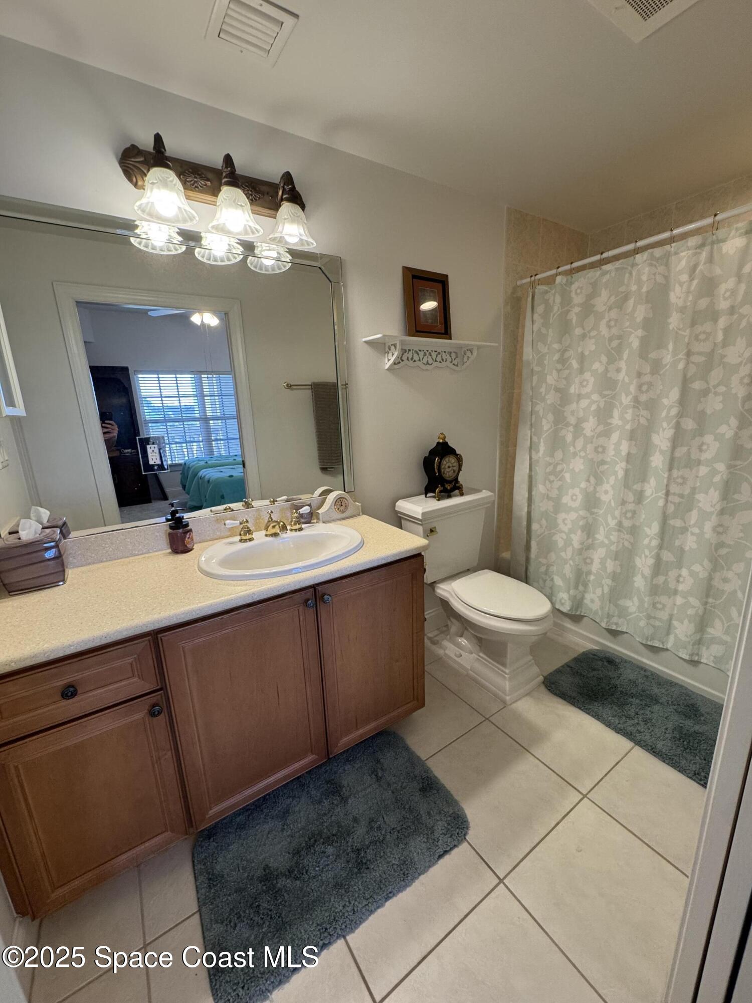 4955 Dixie Highway Northeast, Unit 502 Palm Bay, FL 32905 - Photo 15 of 51 a bathroom with a sink a toilet and shower