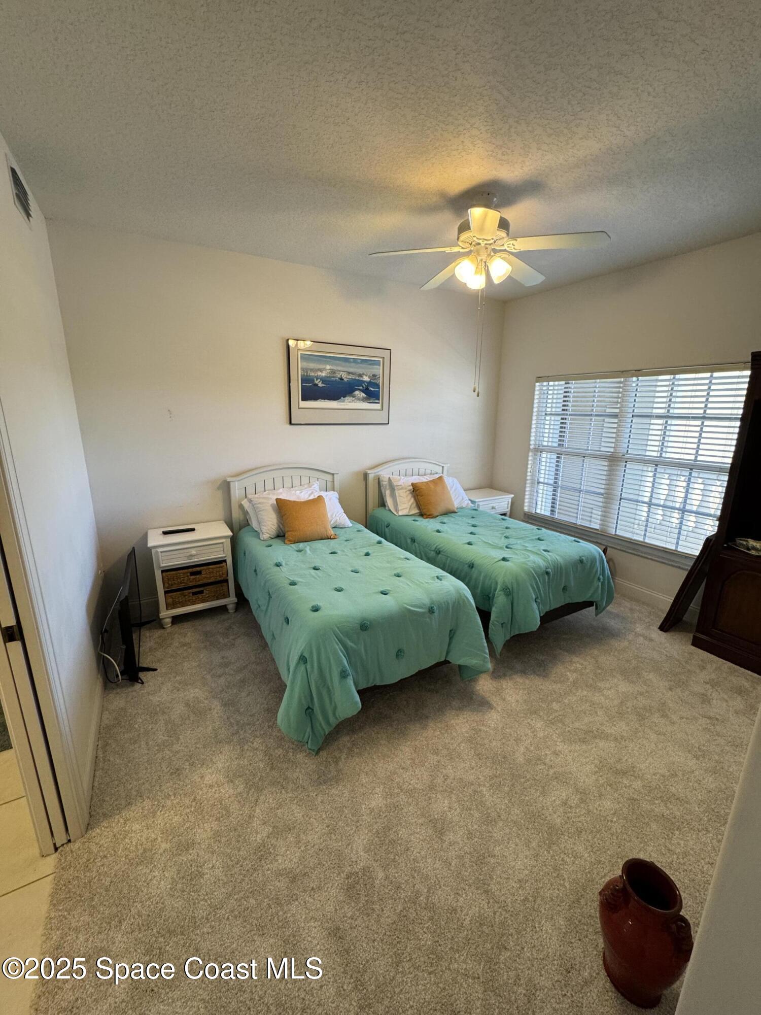 4955 Dixie Highway Northeast, Unit 502 Palm Bay, FL 32905 - Photo 16 of 51 a bedroom with bed and a chandelier