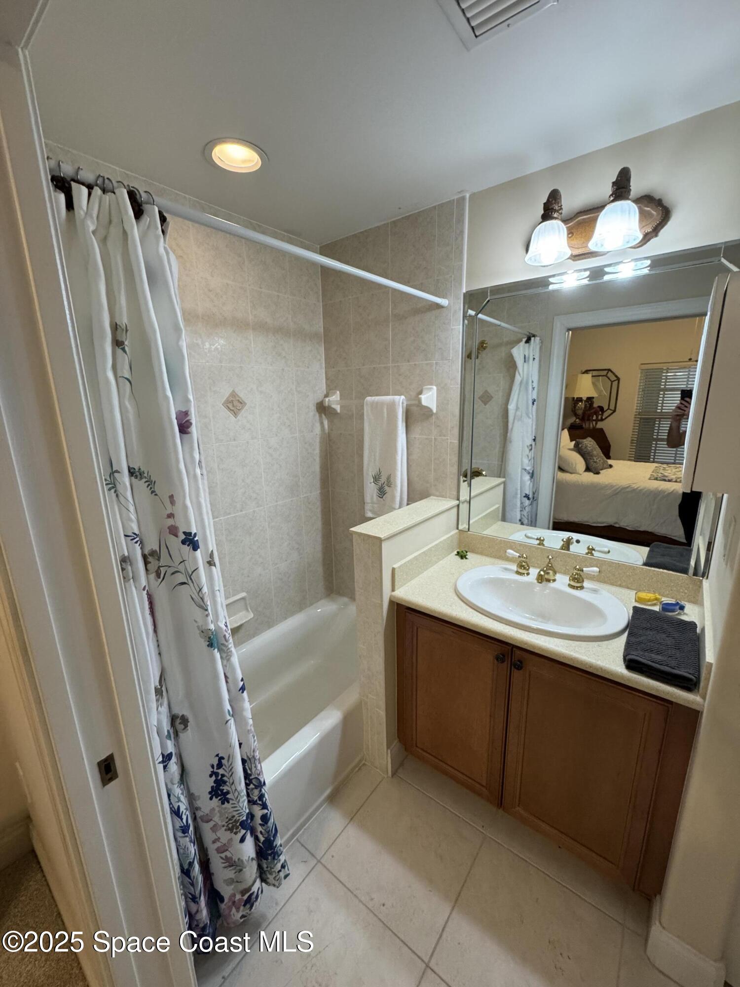 4955 Dixie Highway Northeast, Unit 502 Palm Bay, FL 32905 - Photo 17 of 51 a bathroom with a tub sink and mirror