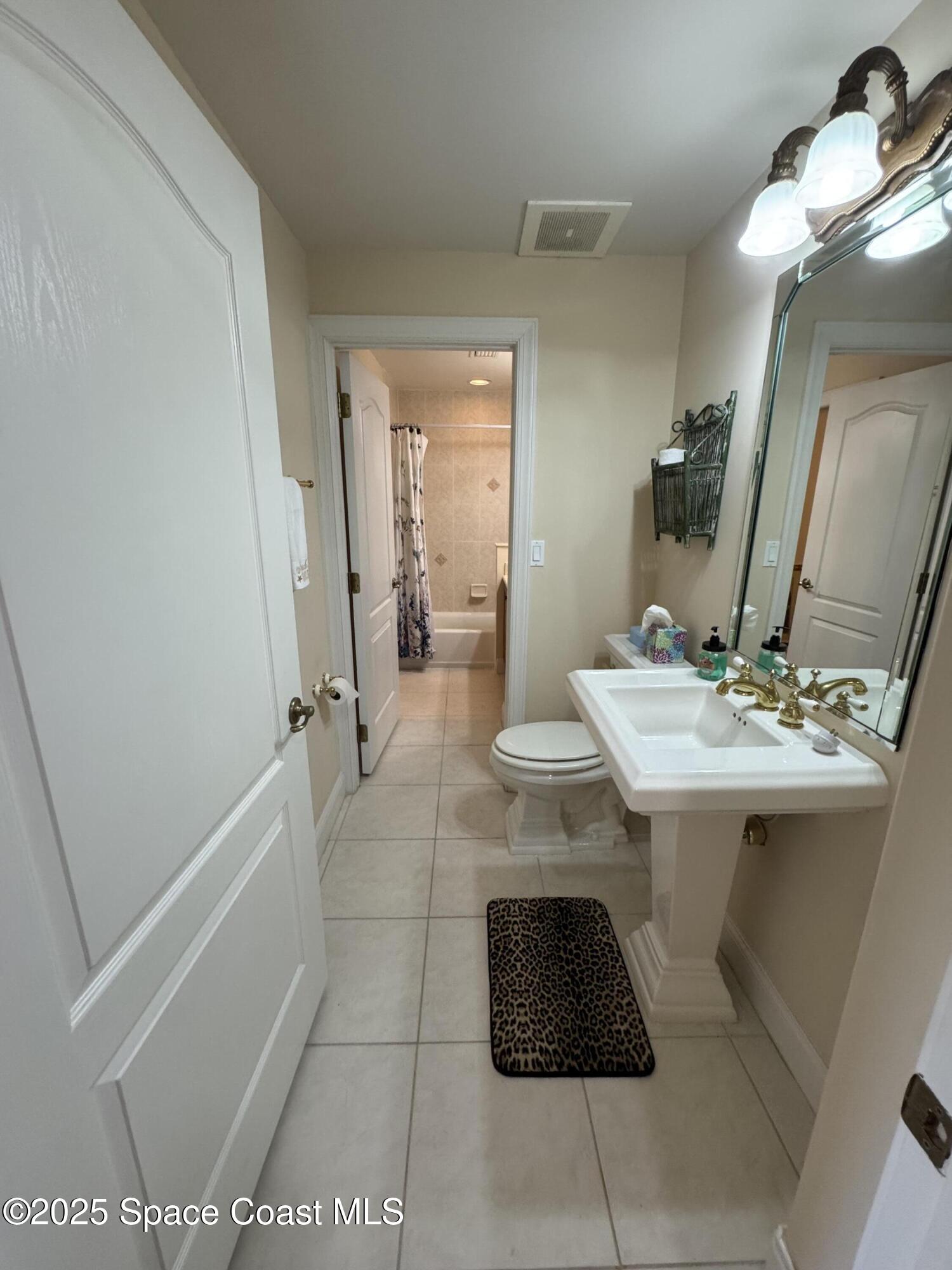 4955 Dixie Highway Northeast, Unit 502 Palm Bay, FL 32905 - Photo 19 of 51 a bathroom with a sink and a mirror