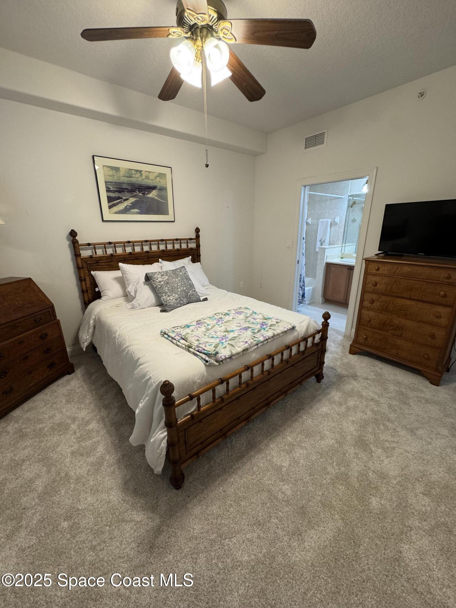 4955 Dixie Highway Northeast, Unit 502 Palm Bay, FL 32905 - Photo 21 of 51 a bedroom with a bed and a walk in closet