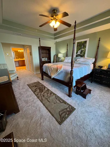 a bedroom with a bed a dresser and window
