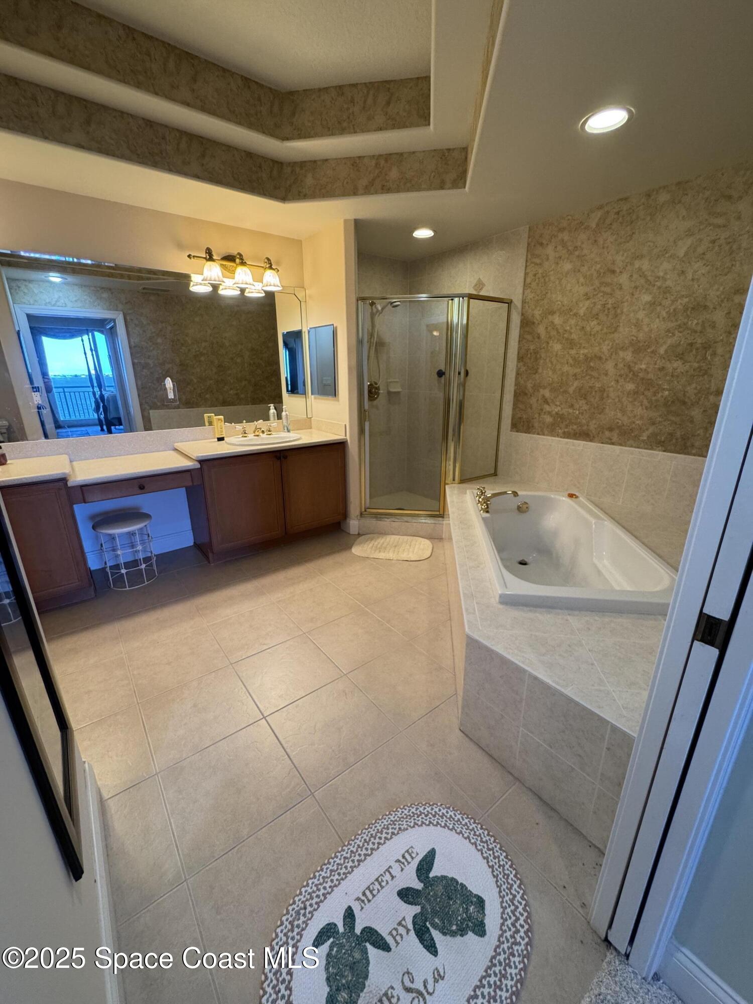 4955 Dixie Highway Northeast, Unit 502 Palm Bay, FL 32905 - Photo 27 of 51 a bathroom with a tub a sink and a shower