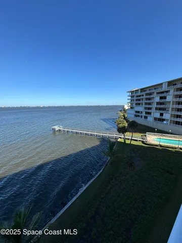a view of a patio with chairs and tables