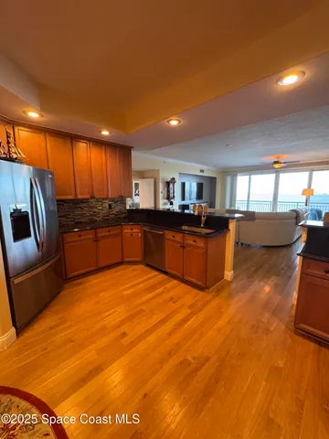a kitchen with stainless steel appliances wooden cabinets sink and stove