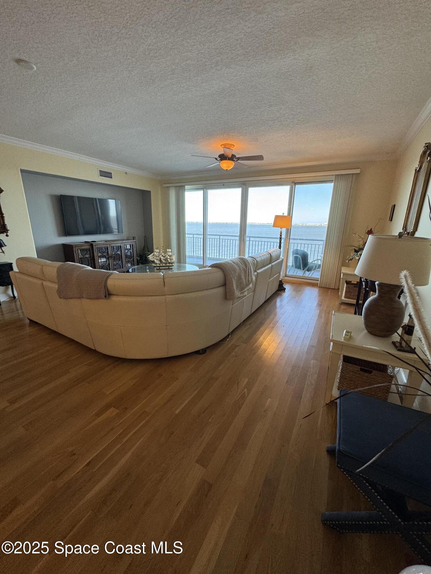 4955 Dixie Highway Northeast, Unit 502 Palm Bay, FL 32905 - Photo 10 of 51 a living room with furniture and a flat screen tv