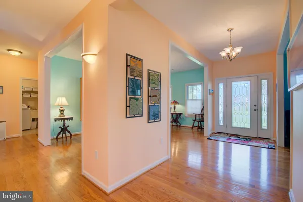 a view of a dining room with furniture wooden floor and chandelier