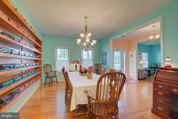 a living room with furniture flat screen tv and a large window