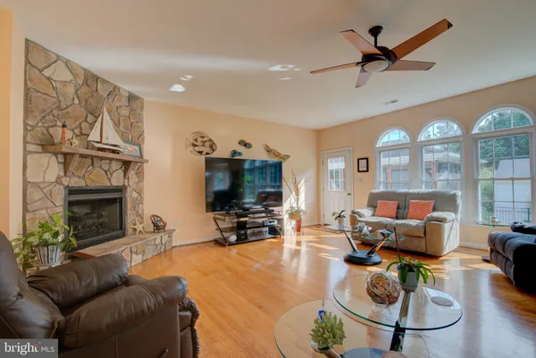 a living room with furniture a flat screen tv and kitchen view