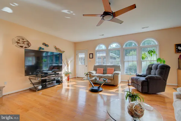 a living room with furniture kitchen view and a fireplace