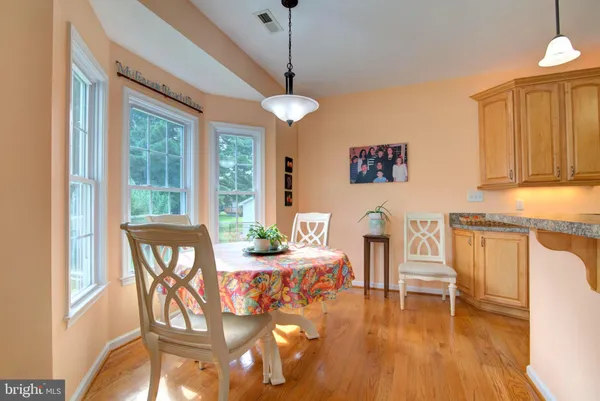 a kitchen with stainless steel appliances granite countertop a refrigerator stove a sink and dishwasher with wooden floor