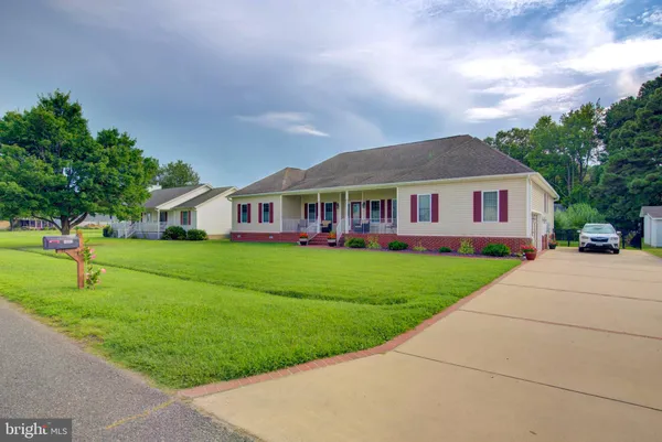 a front view of house with yard and green space