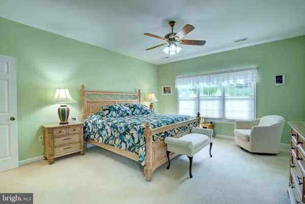 a spacious bathroom with a tub sink and mirror