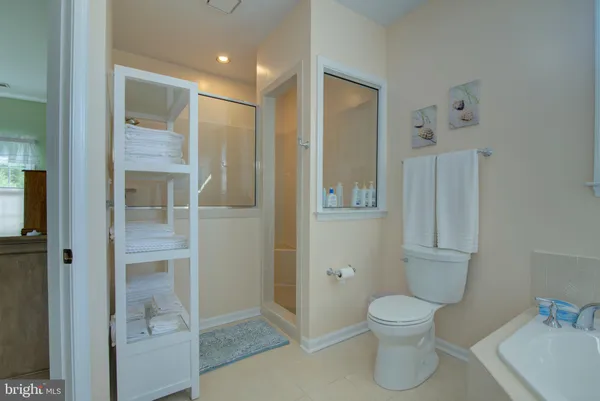 a bedroom with a bed and a view of living room