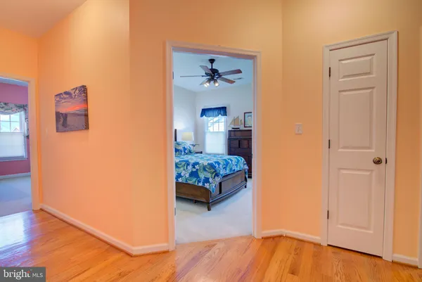 a bedroom with a bed a chandelier and dresser