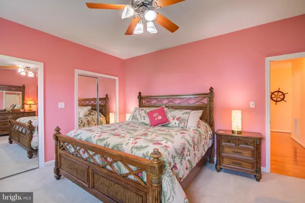 a bedroom with a bed and dresser with mirror