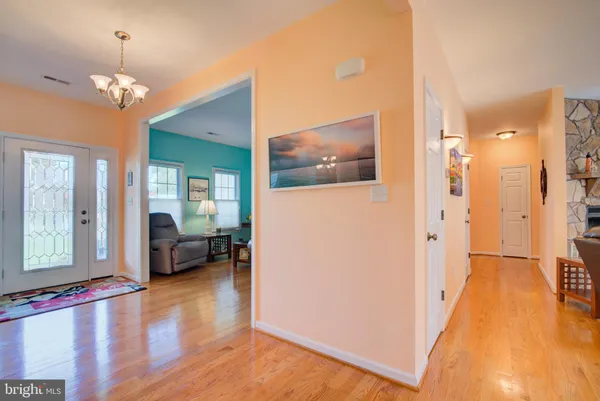 a view of a livingroom with furniture hardwood floor and a chandelier