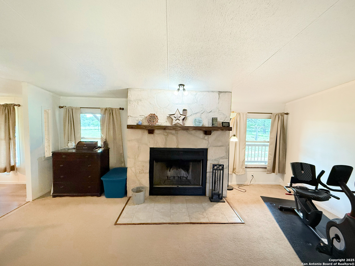 227 River Bluff Drive Lytle, TX 78052 - Photo 11 of 45 a living room with furniture and a fireplace