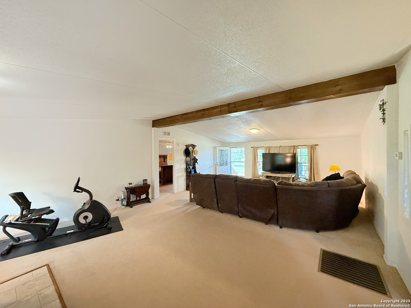 227 River Bluff Drive Lytle, TX 78052 - Photo 12 of 45 a living room with furniture and a flat screen tv