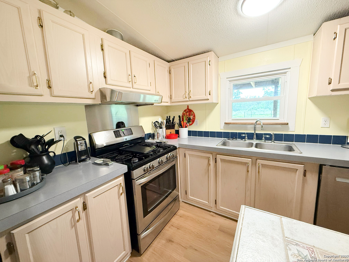 227 River Bluff Drive Lytle, TX 78052 - Photo 16 of 45 a kitchen with stainless steel appliances granite countertop a stove and a sink