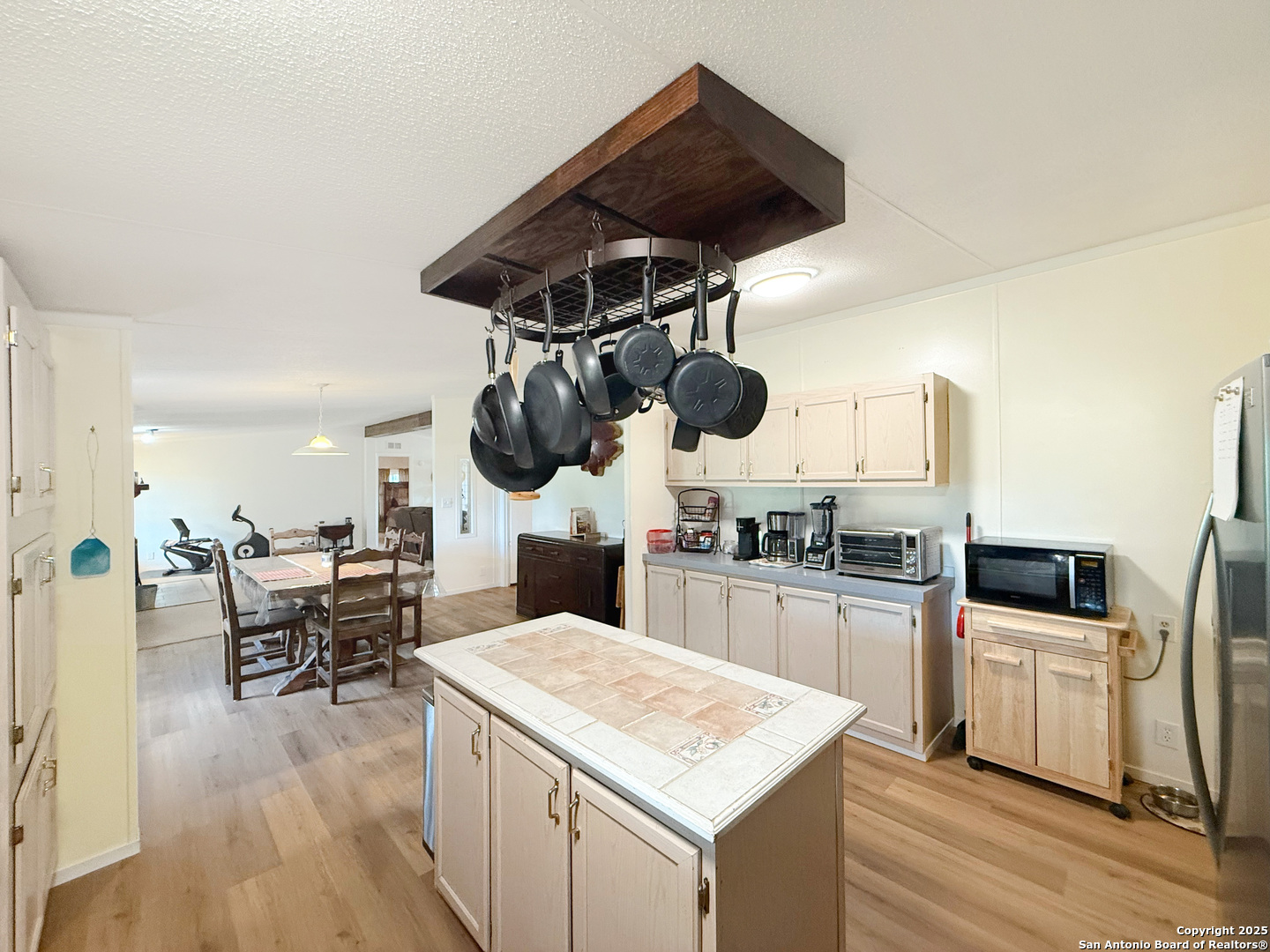 227 River Bluff Drive Lytle, TX 78052 - Photo 17 of 45 a kitchen with a stove a chandelier and chairs
