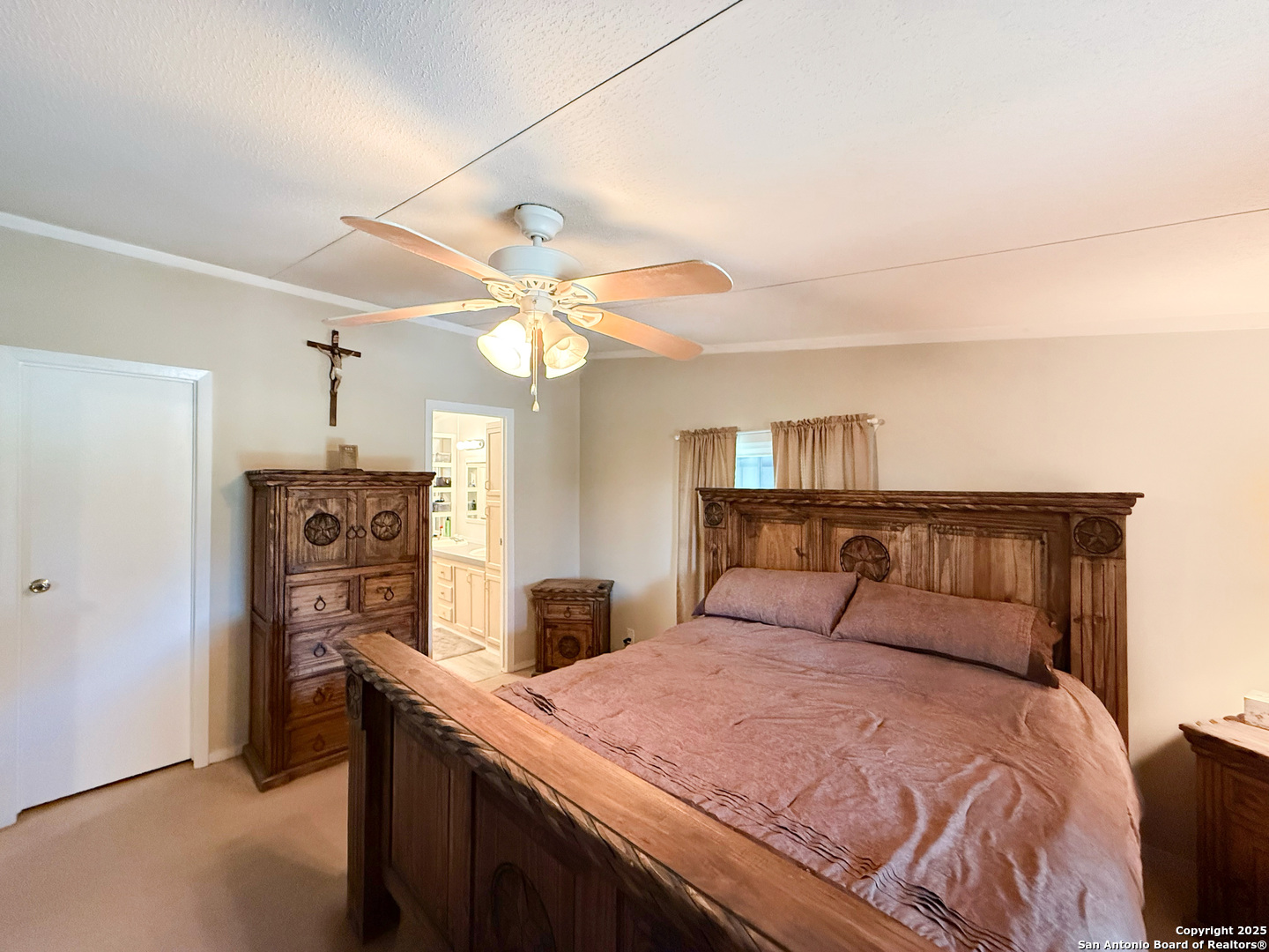 227 River Bluff Drive Lytle, TX 78052 - Photo 21 of 45 a bedroom with a bed and a chandelier
