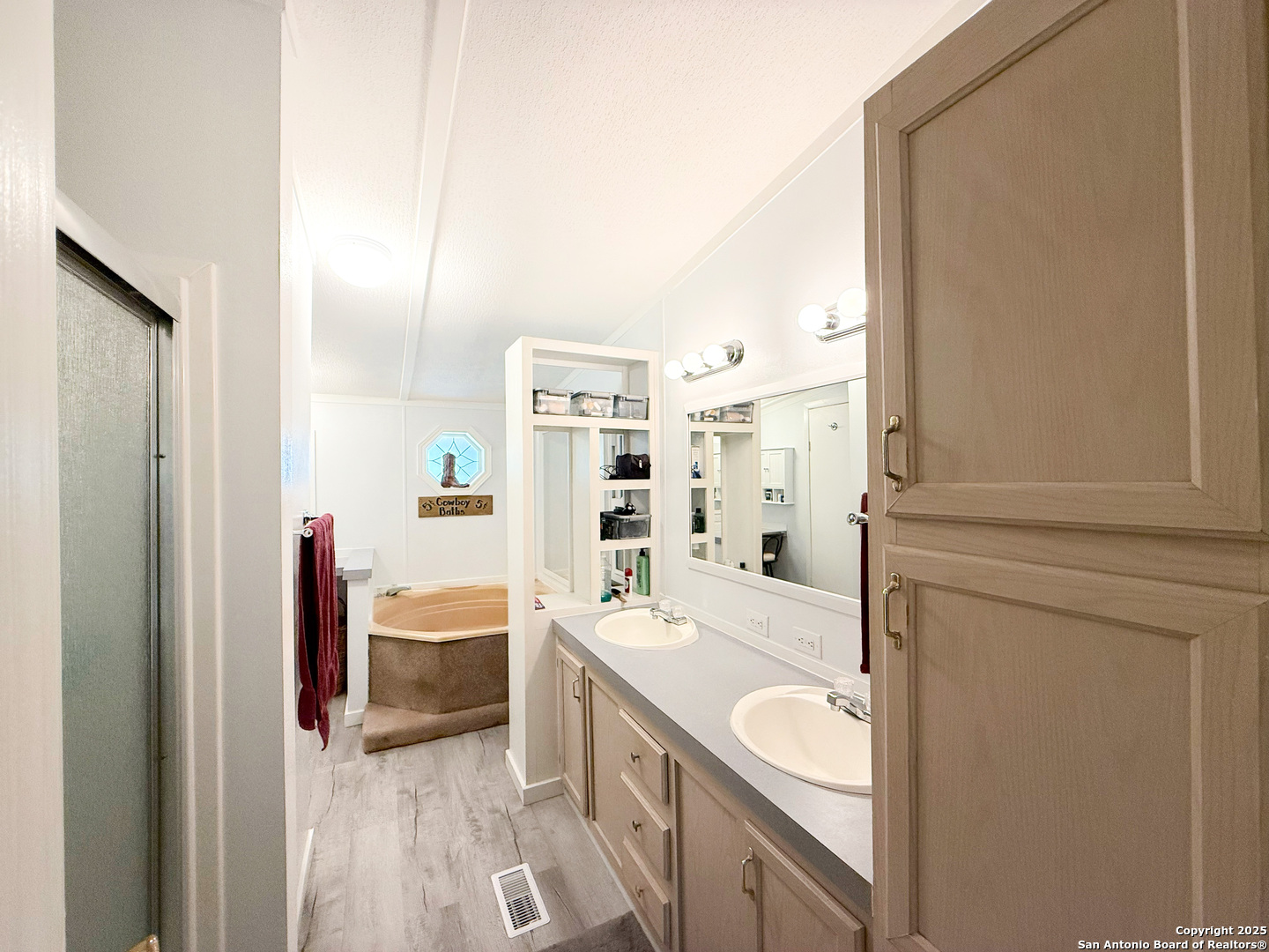 227 River Bluff Drive Lytle, TX 78052 - Photo 22 of 45 a bathroom with a granite countertop sink and a mirror