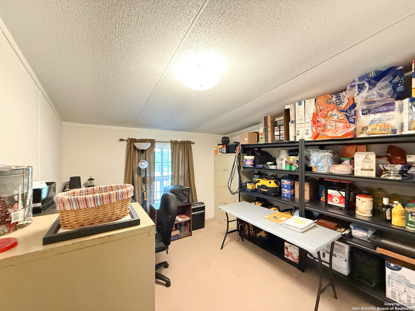 227 River Bluff Drive Lytle, TX 78052 - Photo 25 of 45 a bedroom with furniture and a book shelf