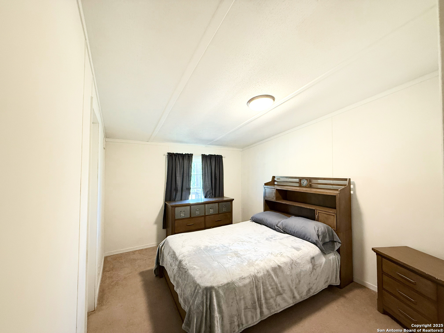 227 River Bluff Drive Lytle, TX 78052 - Photo 30 of 45 a bedroom with a bed and a closet