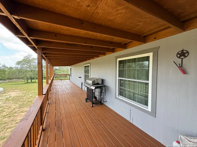 a view of a balcony with chairs and wooden floor