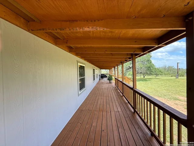 a view of balcony with wooden floor