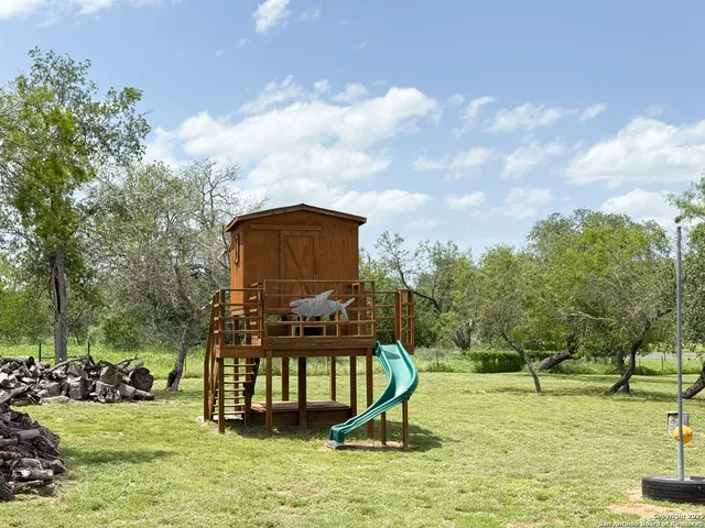 a swimming pool with lots of tress in front of it