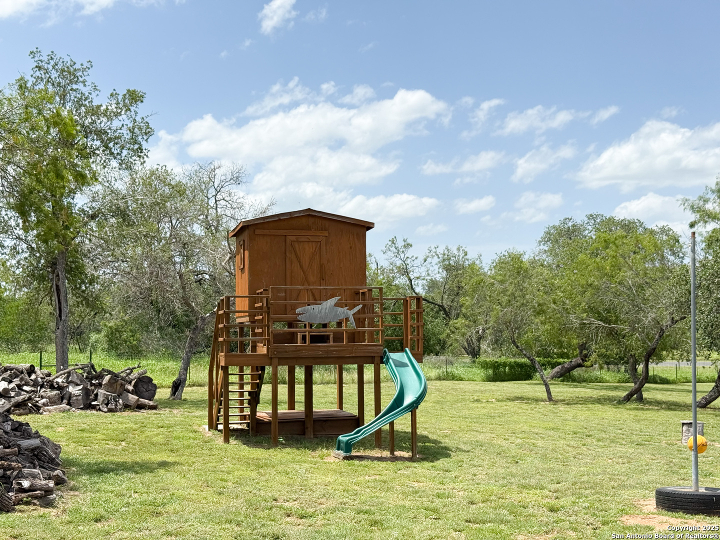 227 River Bluff Drive Lytle, TX 78052 - Photo 9 of 45 a swimming pool with lots of tress in front of it