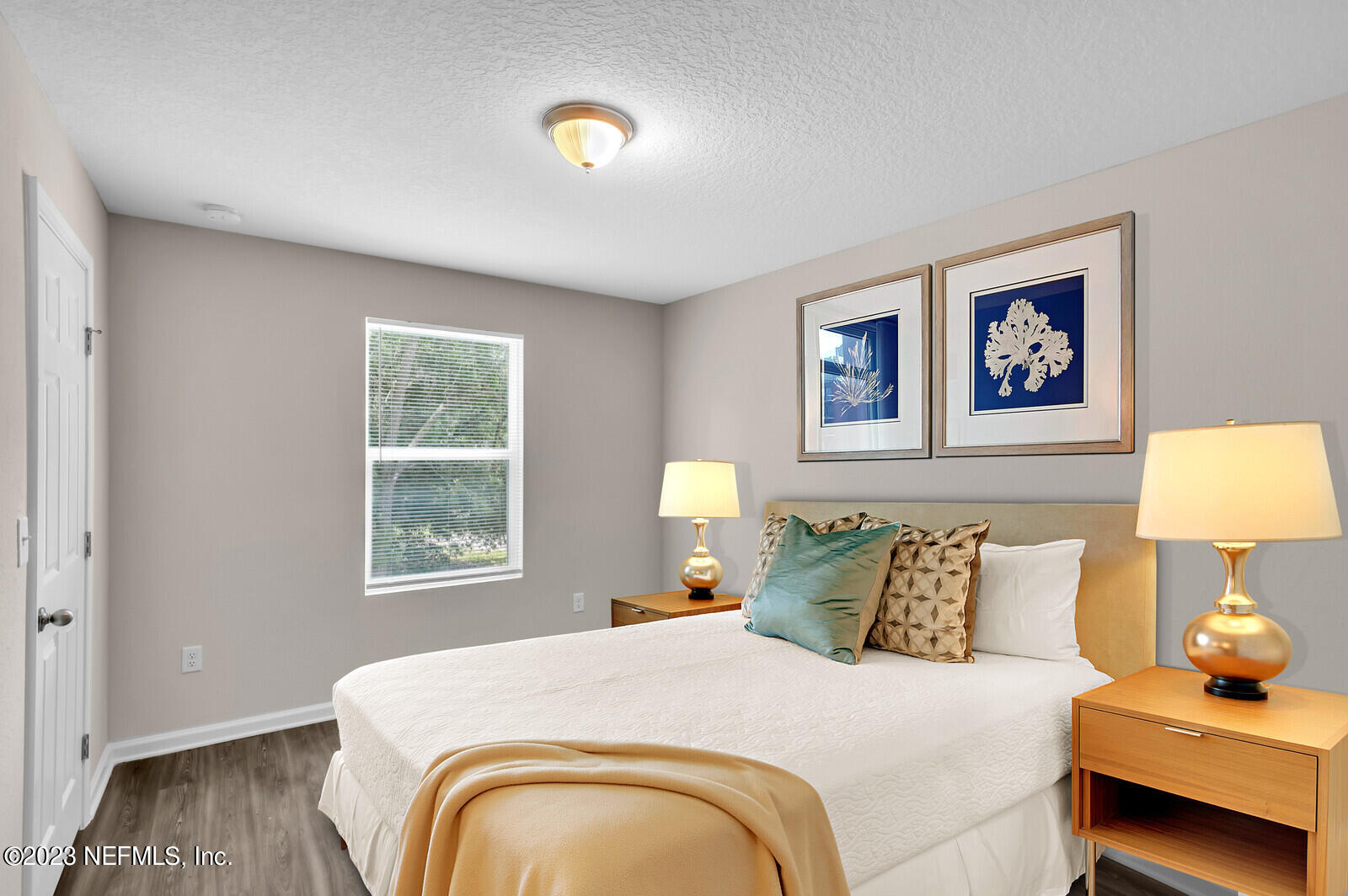 1705 Wright Avenue Jacksonville, FL 32207 - Photo 13 of 22 a bedroom with a bed and a lamp on dresser